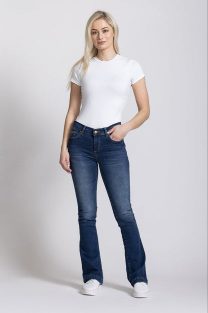 Woman wearing a white t-shirt and blue jeans on a white background
