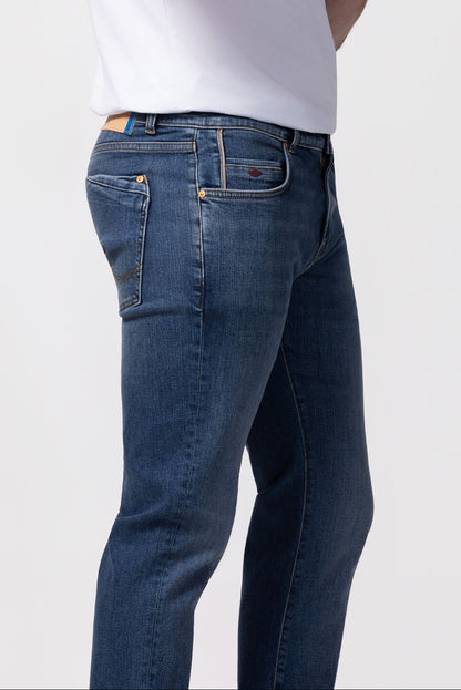 Person wearing blue jeans and a white t-shirt on a white background